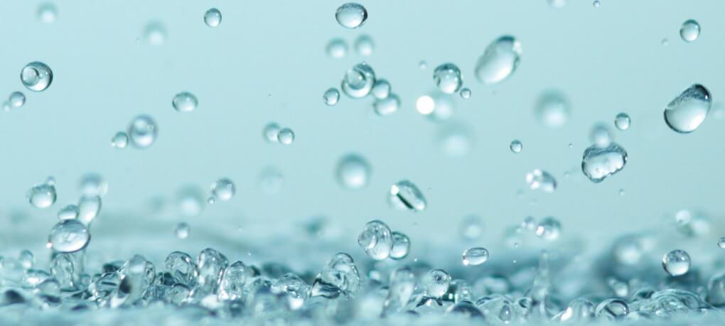 Water droplets on a teal background